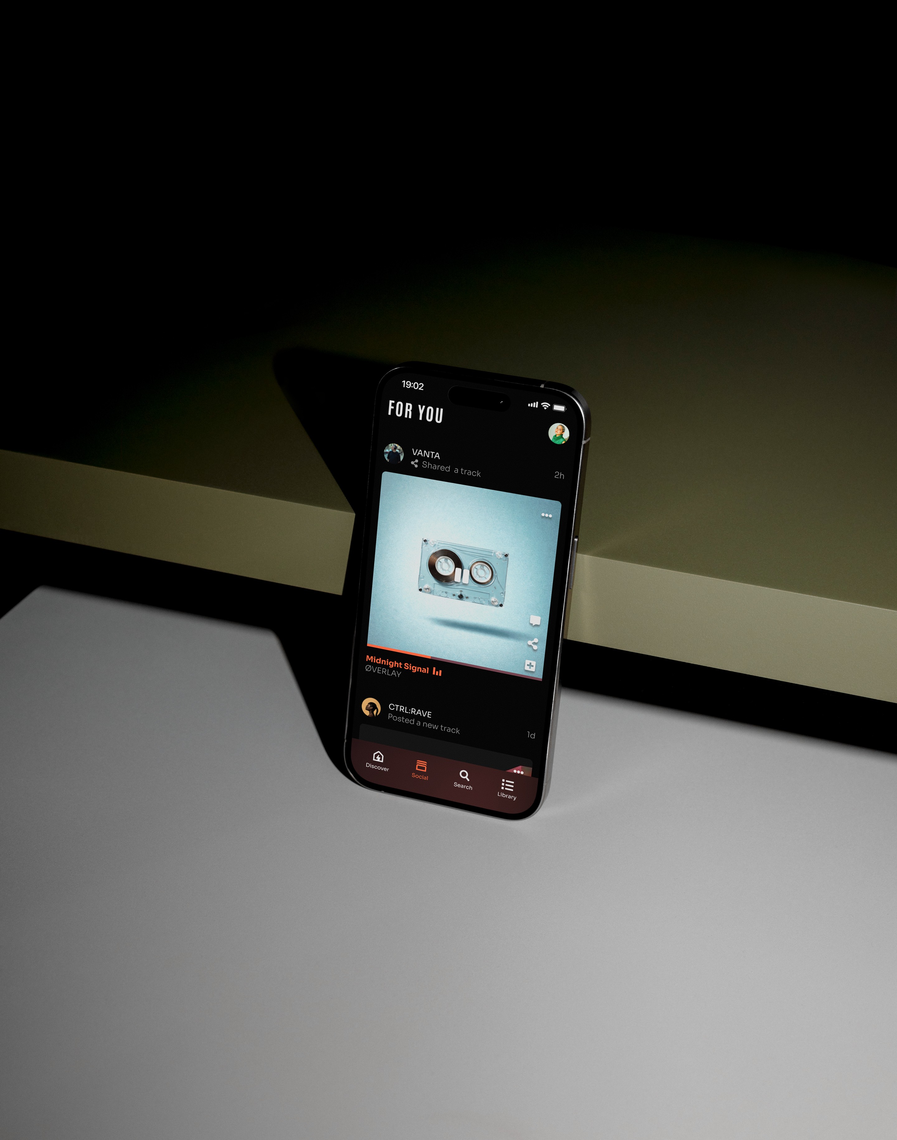 Macbook displaying a design, placed on a wooden table with beige curtains in the background.